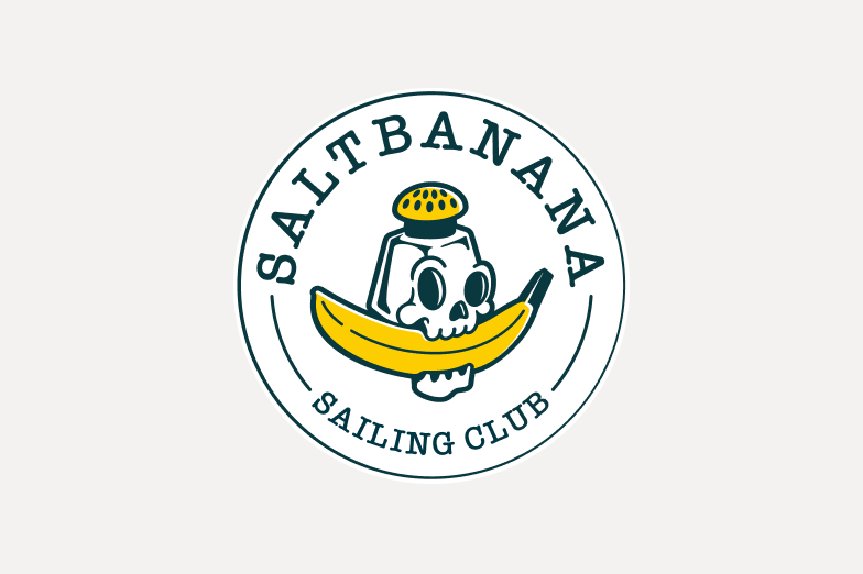 A logo created for a sailing club with a salt shaker in the shape of a skull that has a banana it it's mouth